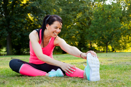 Young woman enjoying herself exercising in the parkの写真素材