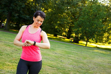 young woman checking her fitness watchの写真素材