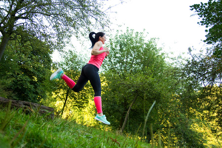 young woman running in natureの写真素材
