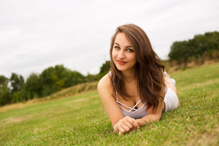pretty girl lying in the parkの写真素材
