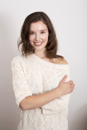 beautiful woman smiling wearing a jumperの写真素材