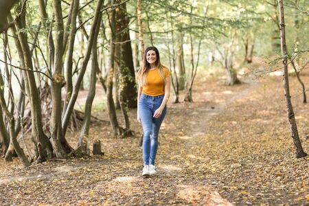 young woman taking a walk in the forestの写真素材