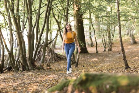 young woman enjoying a walk in the forestの写真素材