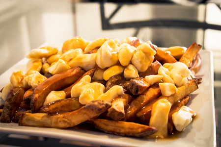 Homemade Poutine on Glass Tableの写真素材