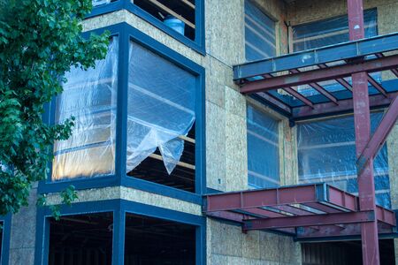 Construction site showing frame of structure. Closeup of window. Sun beam.の写真素材