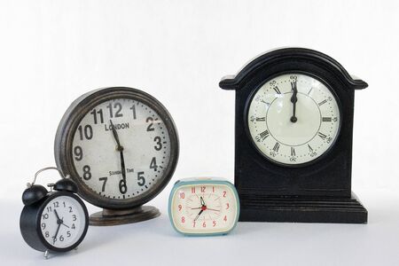 Different size clocks on a white isolated background