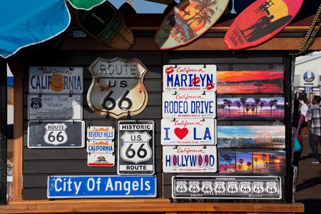Signs and license plates for sale on a stall on Santa Monica Pier, Santa Monica, Californiaのeditorial素材