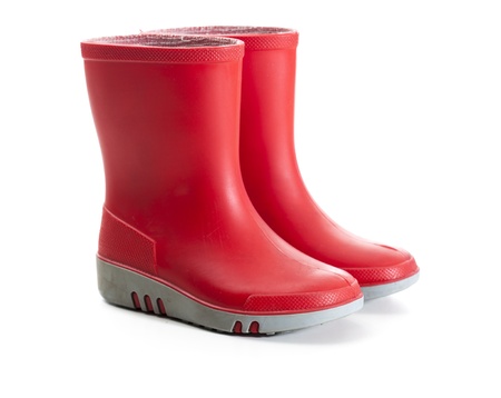 Pair of red wellies in kids size. Tilted side view.Studio shot, isolated on white background.の写真素材
