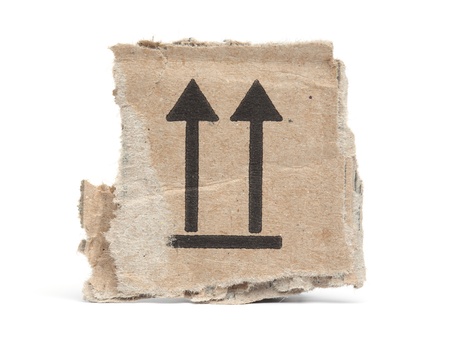 Cardboard ripped from a carton, arrows pointing up to show direction for transportの写真素材