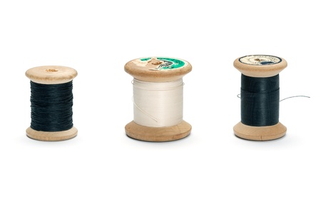 Sewing thread spools in different sizes and colors, isolated on white background.