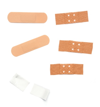 Set of band aids in different sizes, forms and colors. Isolated on white background.の写真素材