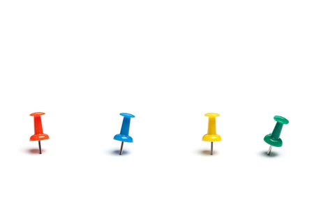 Set of push pins in different colors, with real shadows, isolated on white background.