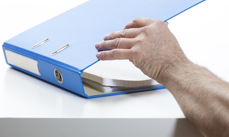 Ring binder in blue color, lying on a desk.Studio shot, isolated on white.の写真素材