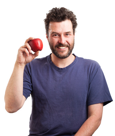 Portrait of a mature Caucasian man with beard and blue shirt, holding a red apple in his hand.の写真素材