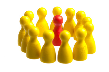 Unique red pawn centered in the middle of a large group. Concept for uniqueness, being stuck in the middle, center.

Cutout, isolated on white.の写真素材