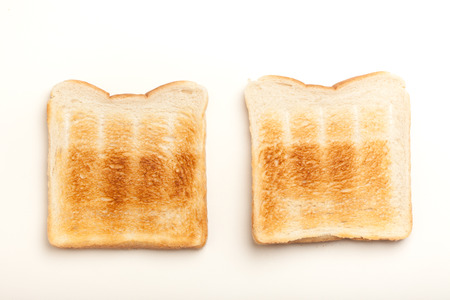 Two slices of bread, toasted perfect. Studio shot on white background.の写真素材