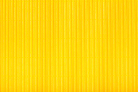 Yellow corrugated cardboard carton in a  colorful texture background series.の写真素材