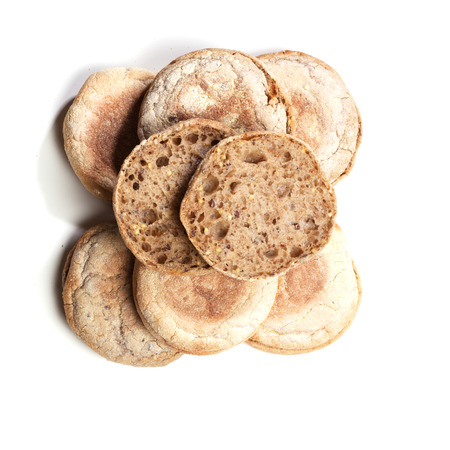 Stack of Italian style bread rolls, top view, isolated on white background.