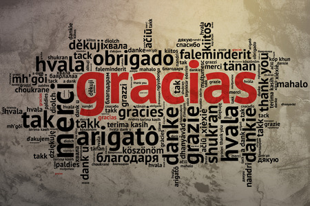 Focus on Spanish - Gracias, Word cloud in open form on Grunge Background. saying thanks in multiple languages.の写真素材