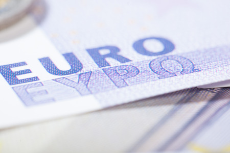 Closeup on bank notes. Shallow depth of field with focus in the center of the letters Euro in Greek and Latin characters.の写真素材