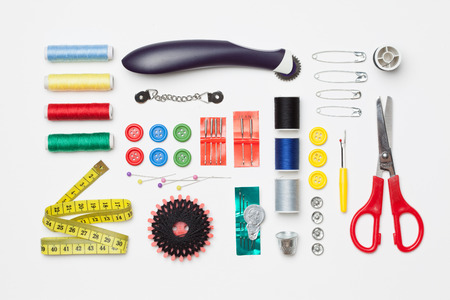 Set of tools with scissors, needle, thread spools for home made embroidery, needlework and tailoring, isolated on white background.の写真素材