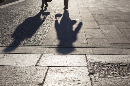 People shadows on streets in sunset, urban city life concept image