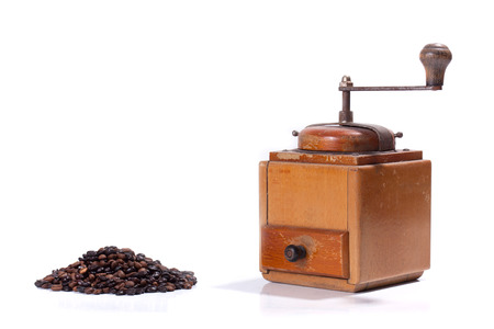 Old coffee mill with beans , isolated on white backgroundの写真素材