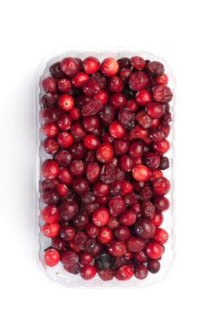 Crate with red cranberries, isolated on white backgroundの写真素材