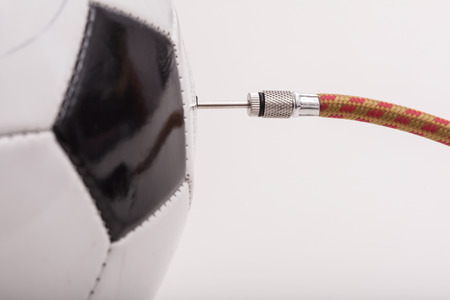 Air pump valve in a football, pumping up sports equipment.の写真素材