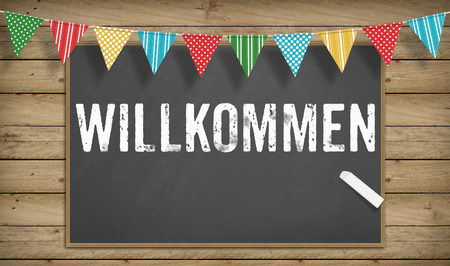 Welcome statement in German (Willkommen) on blackboardの写真素材