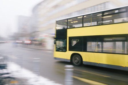 Motion blur image of yellow double deck bus on city street, public transport and speed concept image.の写真素材