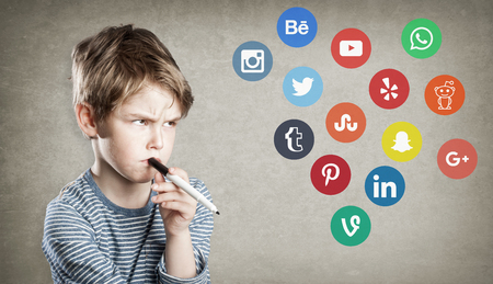 Boy with social media logos, writing and thinking about choice of networkingのeditorial素材