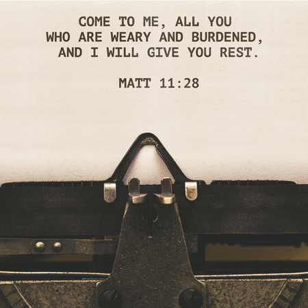 Matt 11:28 Bible quote on paper in vintage type writer machine from 1920s closeup with paper