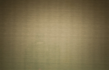 Brass alloy from copper and zinc, blank metal sheet, texture background closeup, intentaional strong vignetting.の写真素材