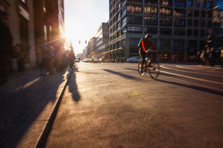 Bicycle speeding on a street in central Berlin shortly before sunset.の写真素材