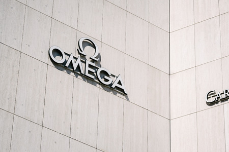 BERLIN, GERMANY - MAY 11, 2017: Omega trademark brand logo of watch manufacturer on store front at...