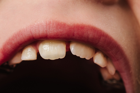 Caucasian European school boy with blond hair and brown eyes, closeup portraitの写真素材