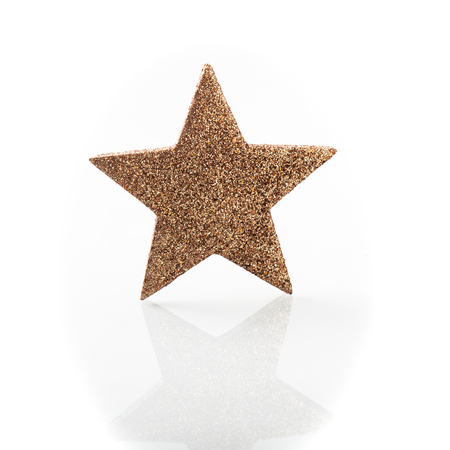 Christmas ornament, golden star decoration isolated on whiteの写真素材
