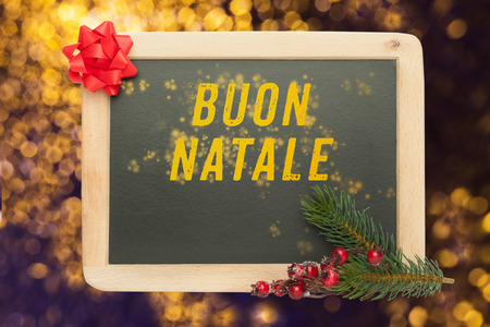 Blackboard with Merry Christmas message, golden sparkles and bokeh backgroundの写真素材