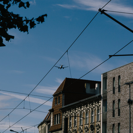 Airplane flying low over buildings in Berlin Pankow during approach to airport Tegelの写真素材