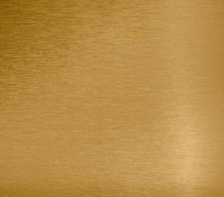 Golden colored texture, blank metal sheet, background closeup.の写真素材