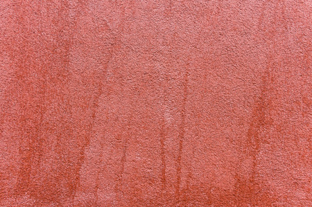 Close up of outside wall with red colored ornate plaster, texture background.の写真素材