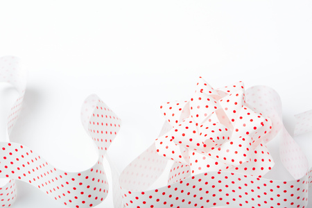 Red dot paper ribbon and tie, Christmas gift packaging decoration, isolated on white background.の写真素材