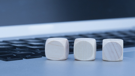 Empty wood cubes standing on laptop computerの写真素材
