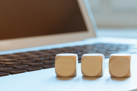 Empty wood cubes standing on laptop computer