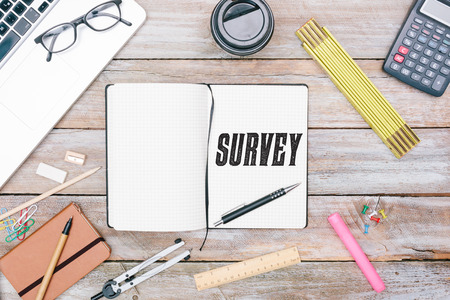 Survey text written in writers journal or diar  with blank space on paper, pencil for writing, grunge office deskt flat lay shot from aboveの写真素材