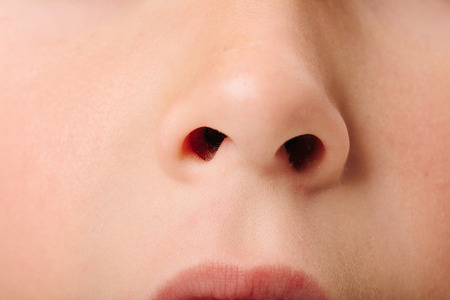 Caucasian European school boy with blond hair and brown eyes, closeup portraitの写真素材
