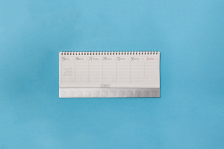 Blank schedule on empty calendar on minimal blue carton paper background with copy spaceの写真素材
