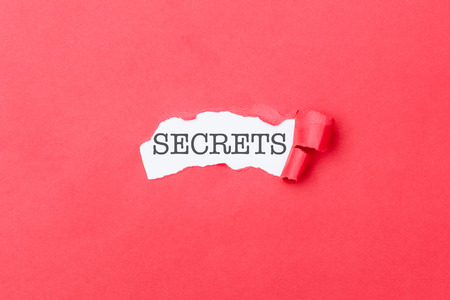 Secrets revealed with shred of ripped pieces of cardboard paperの写真素材