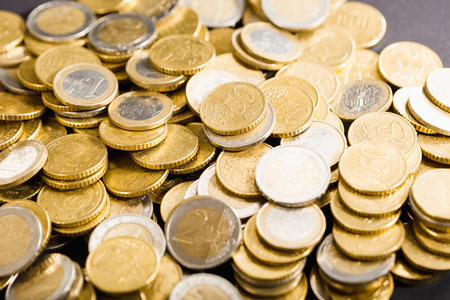 Close-up macro to Euro money coins in  stacks and heaps on a table,